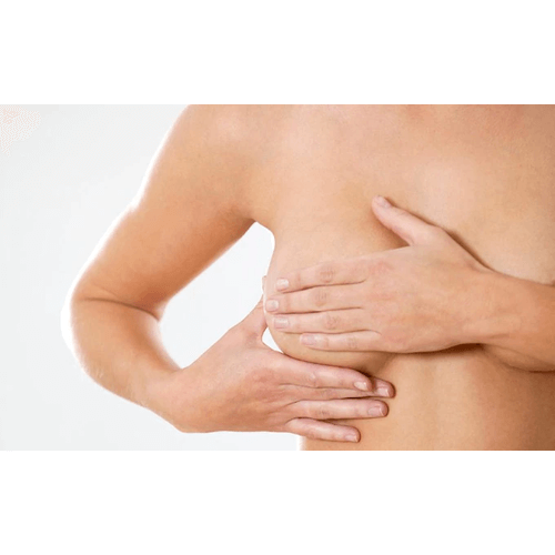 Woman practicing breast health tips for women by examining her breast.