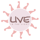 Logo of 'Live In The Light', featuring elegant lighting fixtures design elements.