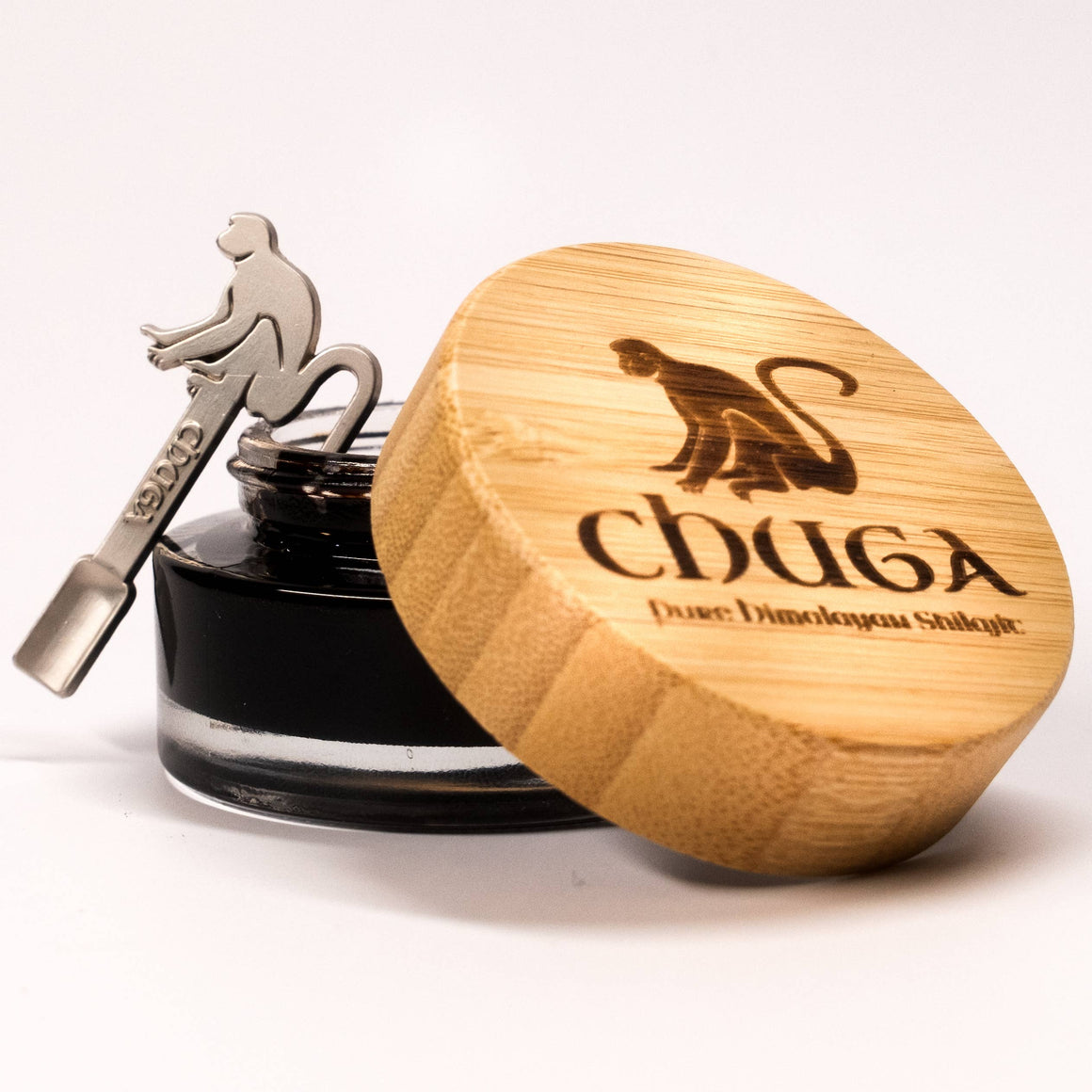 Pure Himalayan Shilajit resin in a jar with a bamboo lid featuring a monkey design.
