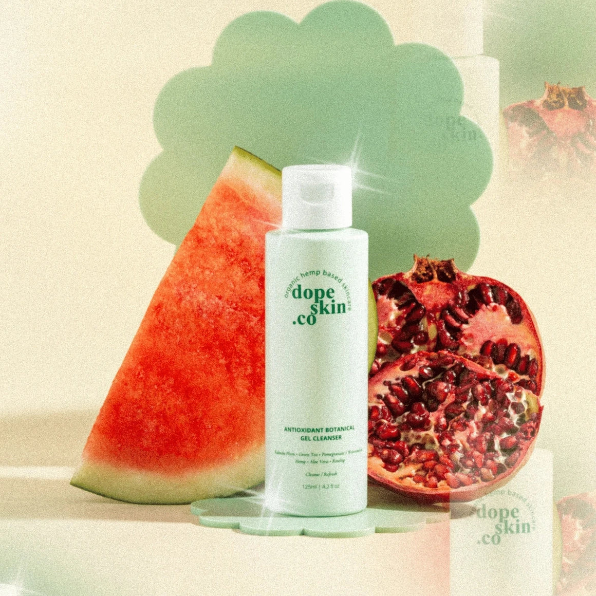 Skincare bottle labeled 'dope skin co' with watermelon and pomegranate on a light background
