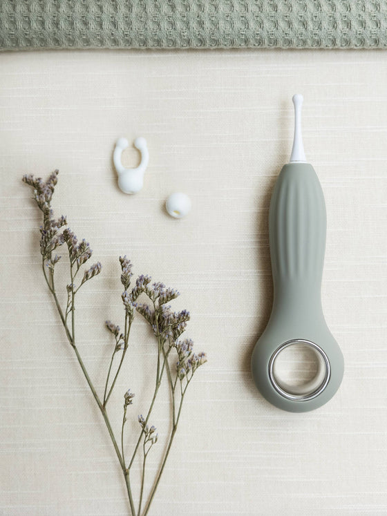 Samphire Precision Vibrator with interchangeable heads, ergonomic design, and premium silicone, styled with gentle florals.