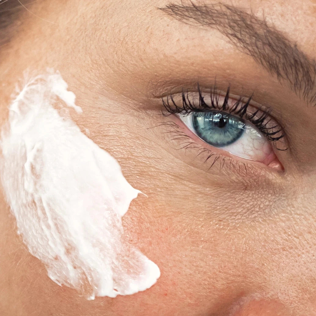 Close-up of a person applying Antioxidant Botanical Moisturiser to their skin for hydration and protection.