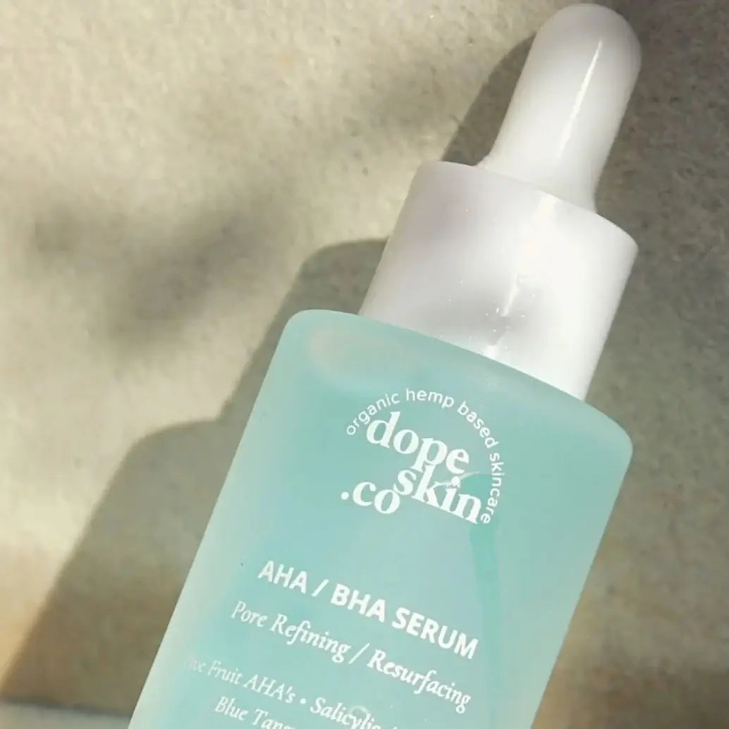 Dope Skin Co AHA/BHA Serum bottle on a neutral background