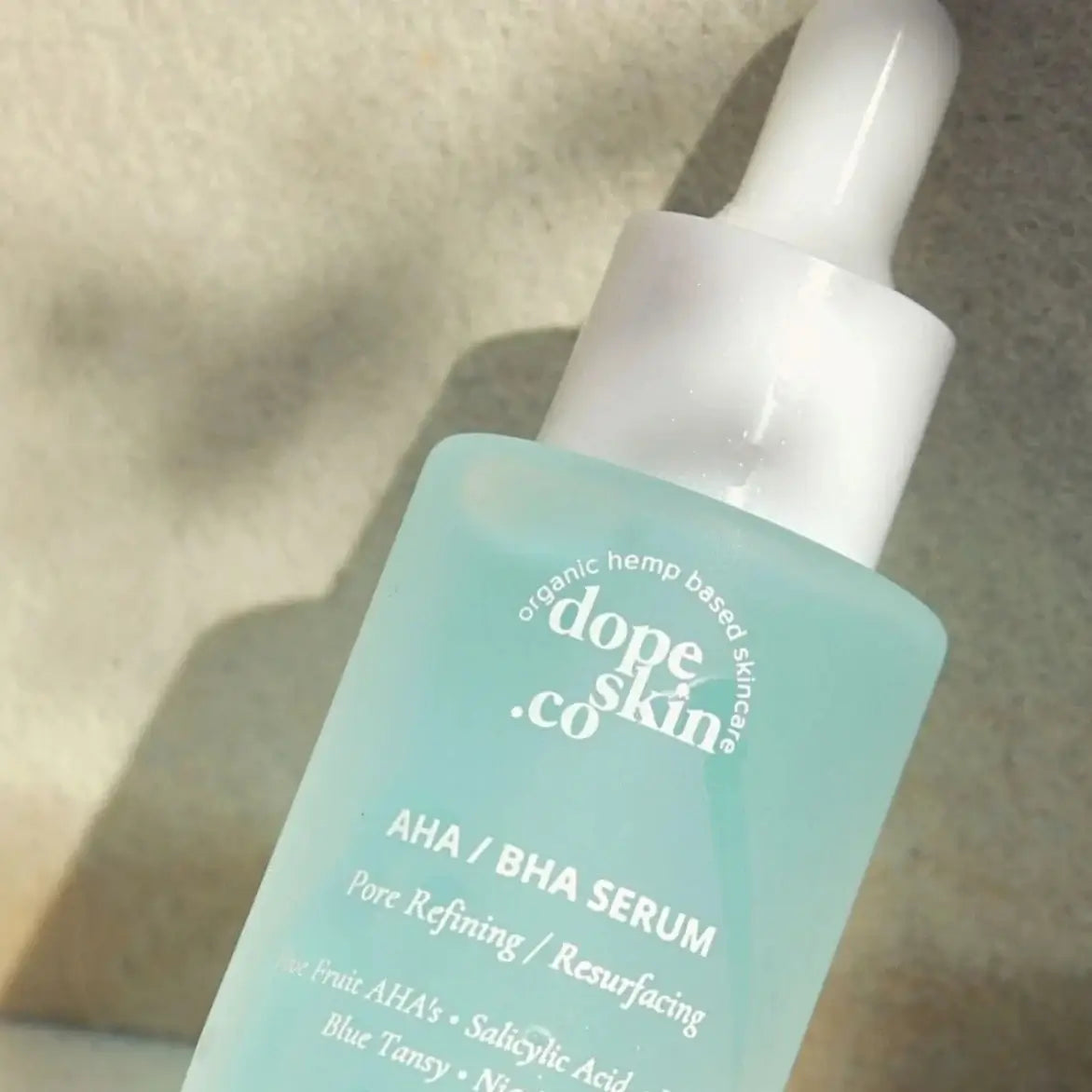 Dope Skin Co. AHA/BHA Serum bottle on a neutral background