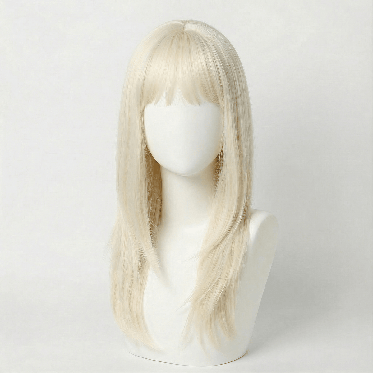 Blonde wig on a mannequin head against a white background