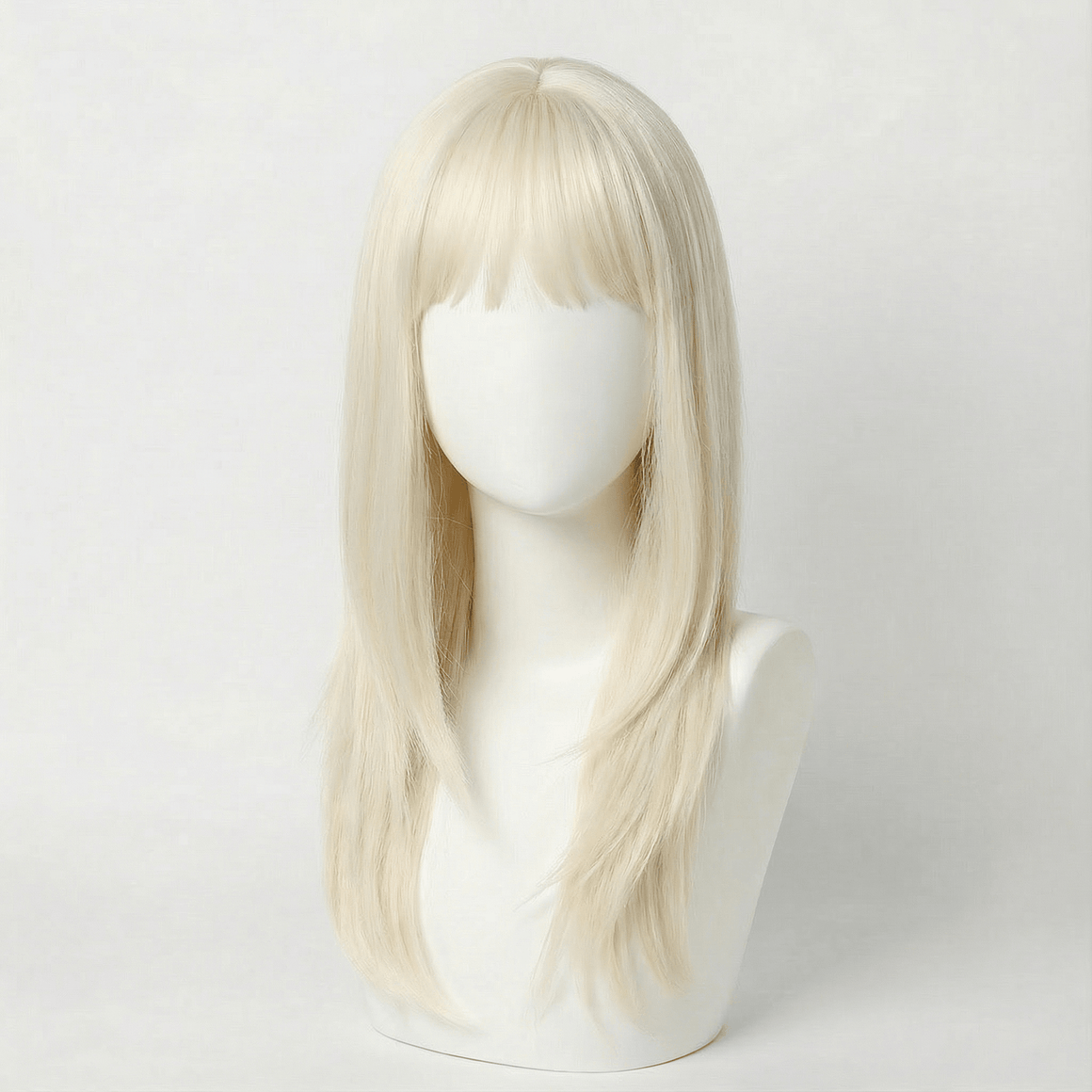 Blonde wig on a mannequin head against a white background
