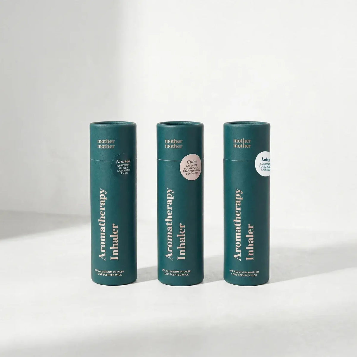 Three green aromatherapy inhaler containers on a white background