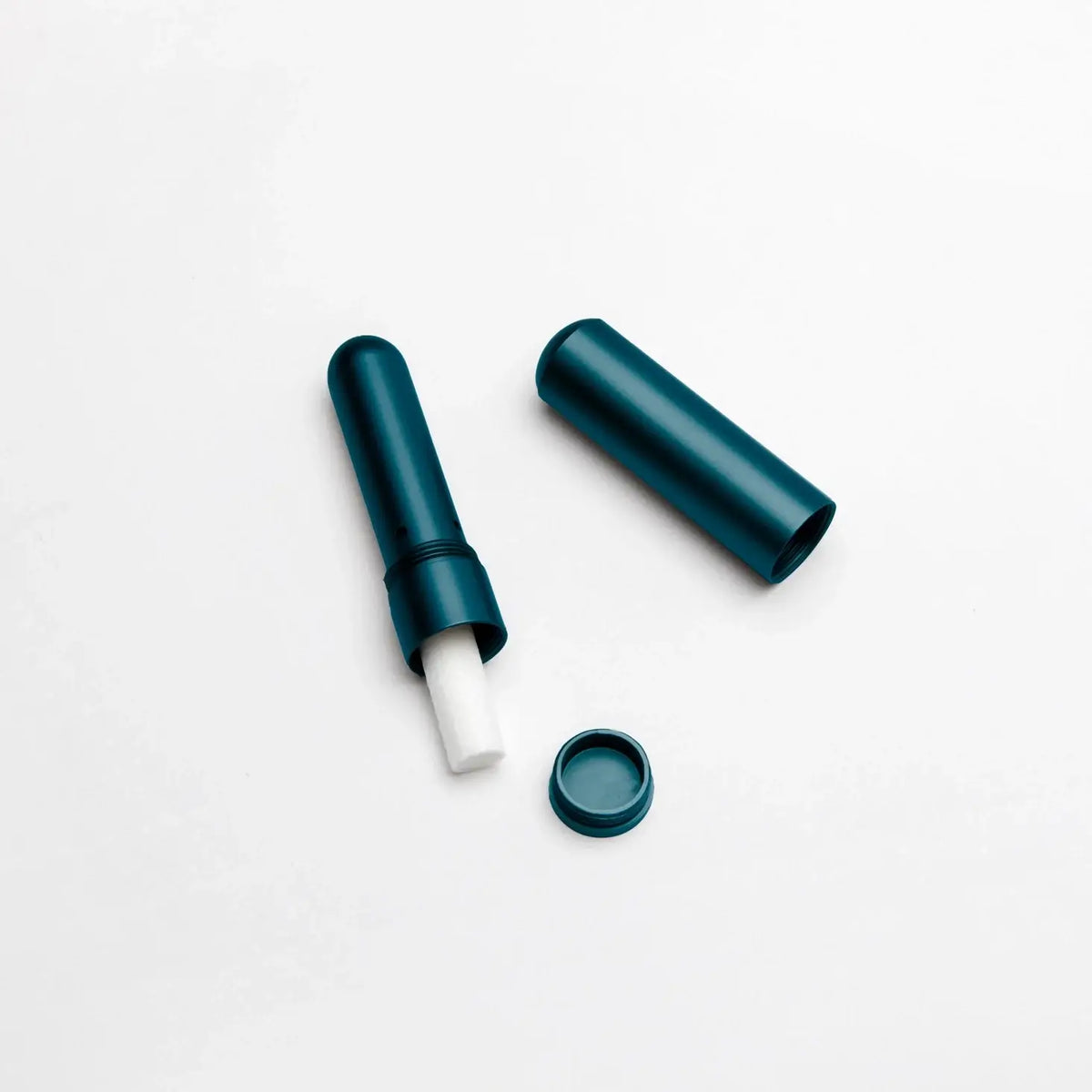 Blue lip balm with cap on a white background