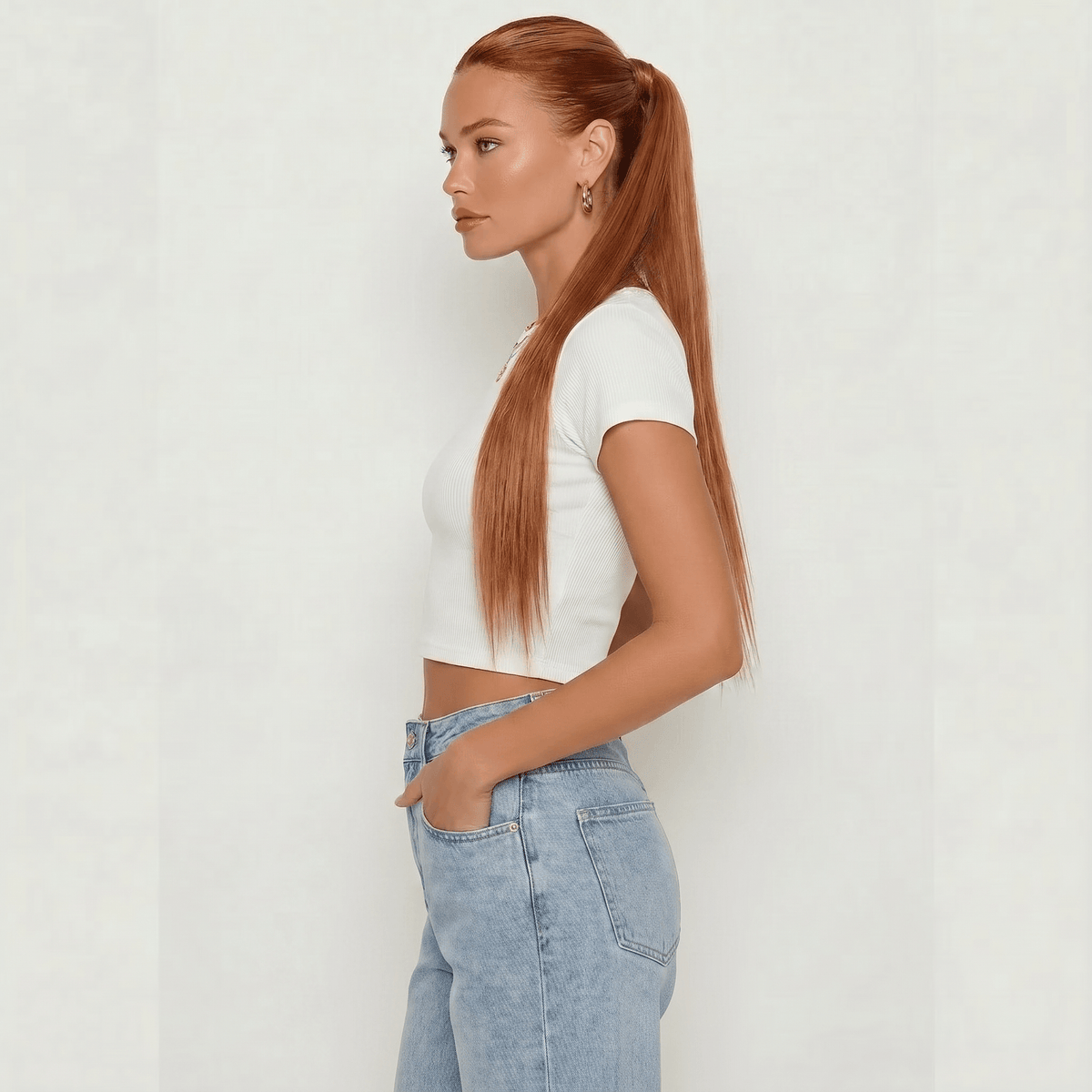 Auburn silky straight ponytail extension styled in a sleek wrap-around ponytail for a chic look.