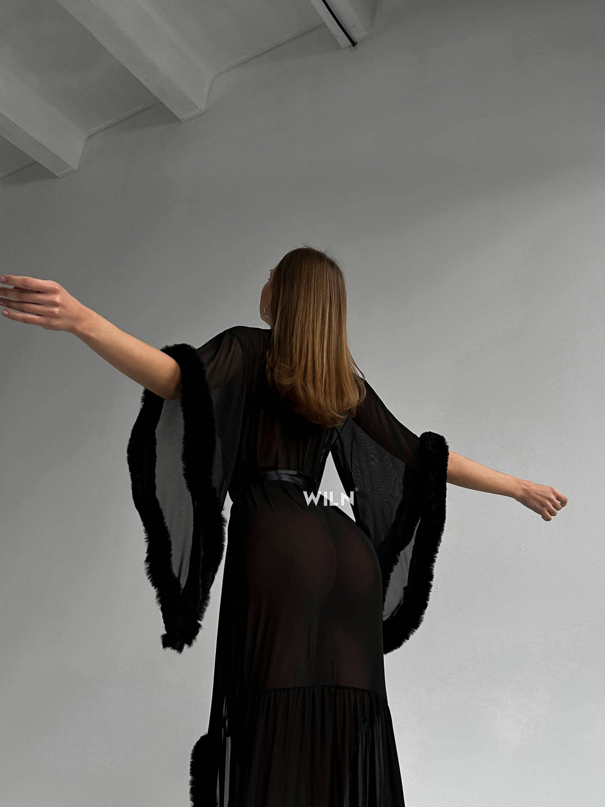 Model wearing a BURLESQUE Soft Mesh Dress, showcasing the elegant sheer fabric and dramatic silhouette.