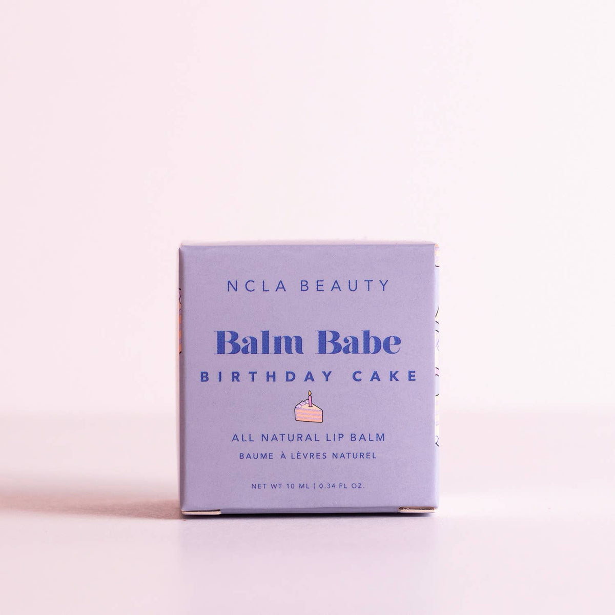 NCLA Beauty Balm Babe Birthday Cake lip balm packaging on a light pink background