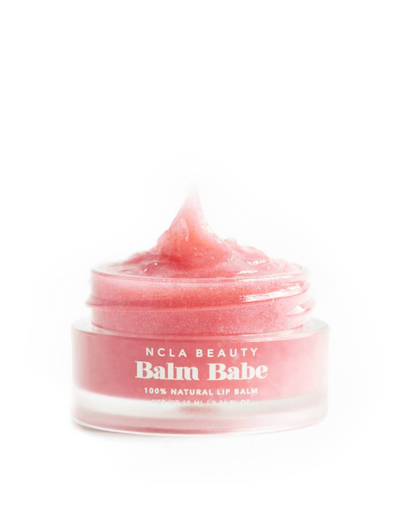 Pink lip balm jar labeled 'Balm Babe' by NCLA Beauty on a white background