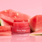NCLA Beauty Balm Babe lip balm jar with watermelon slices on a pink background