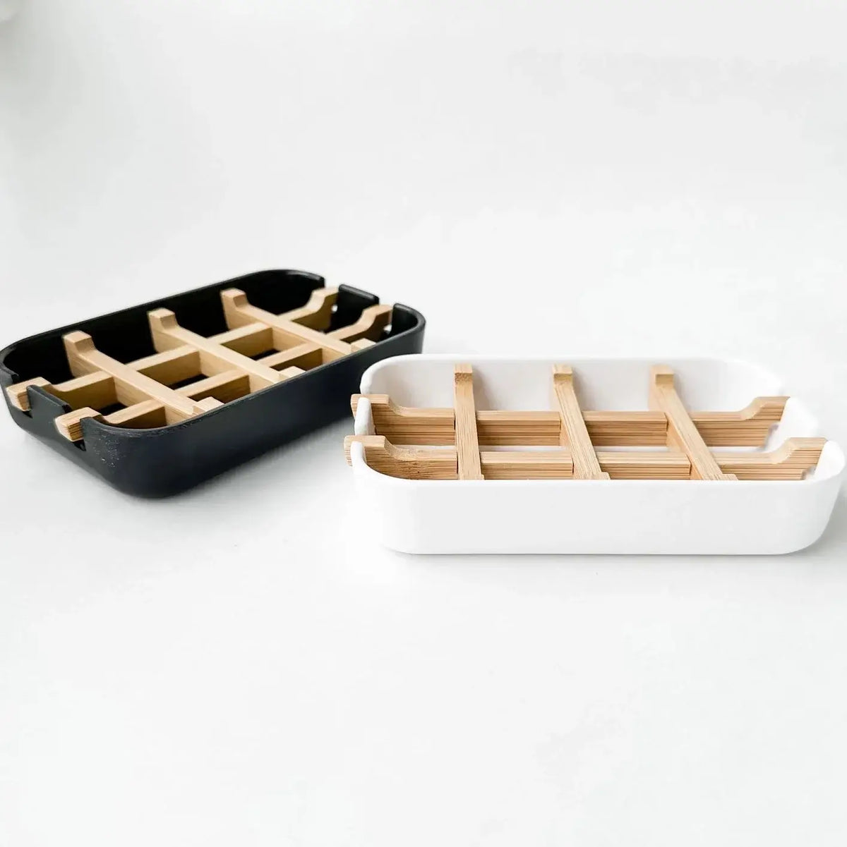 Two trays with wooden compartments on a white background