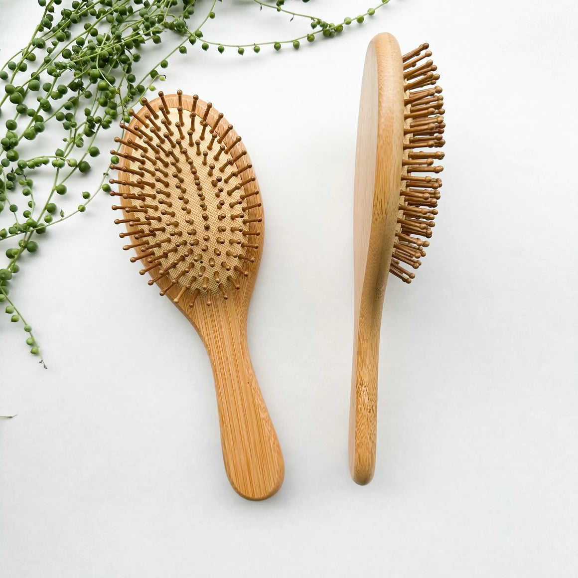 Detangling Bamboo Hair Brush by Smile Boutiques, eco-friendly design with large bamboo bristles for smooth, frizz-free hair.