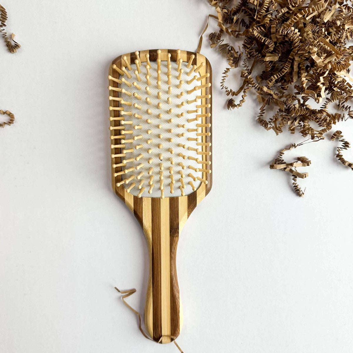 Bamboo Hair Brush - Smile Boutiques, a sustainable paddle hair brush with natural wooden bristles.