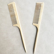 Two wooden combs on a light gray background