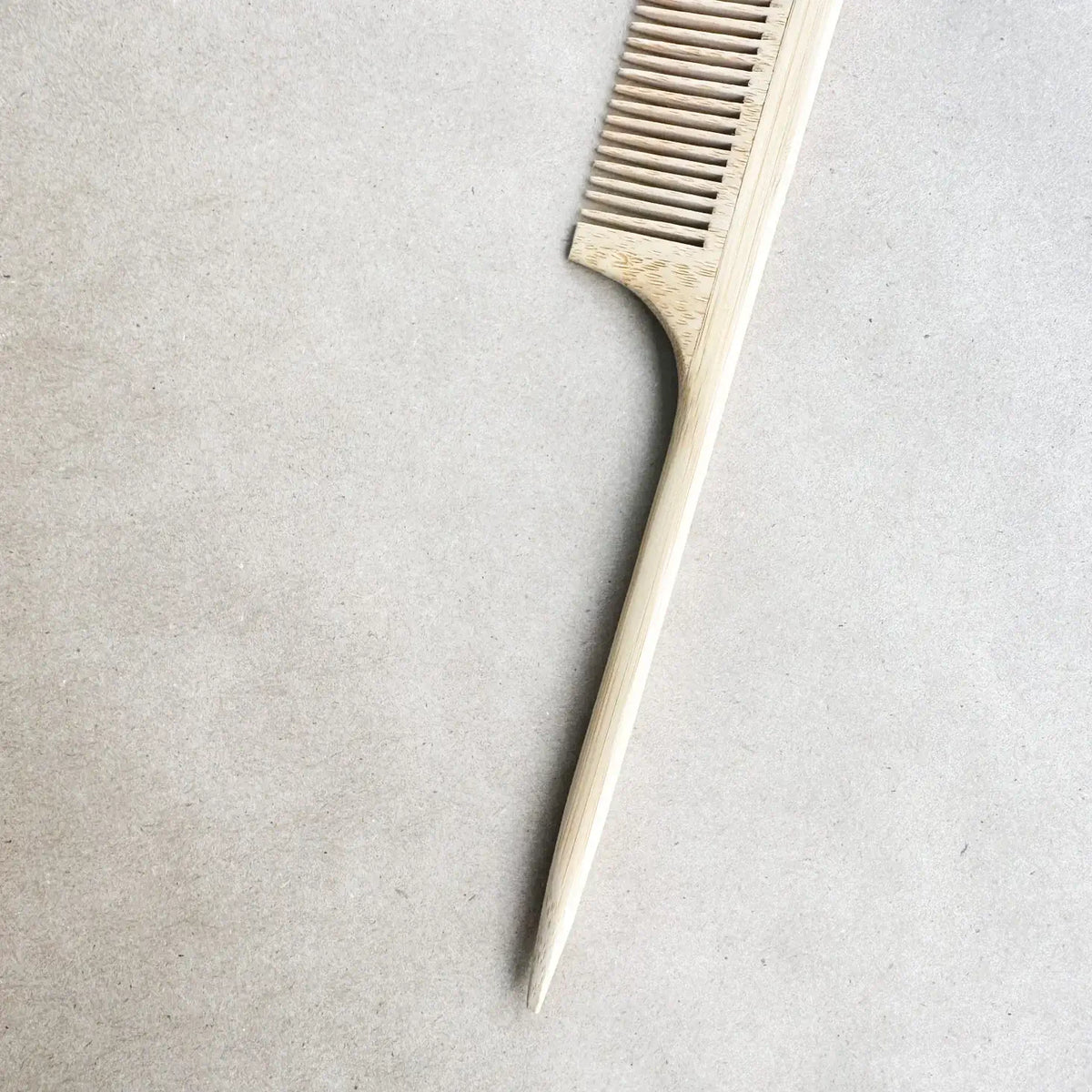 Metallic comb on a textured gray background