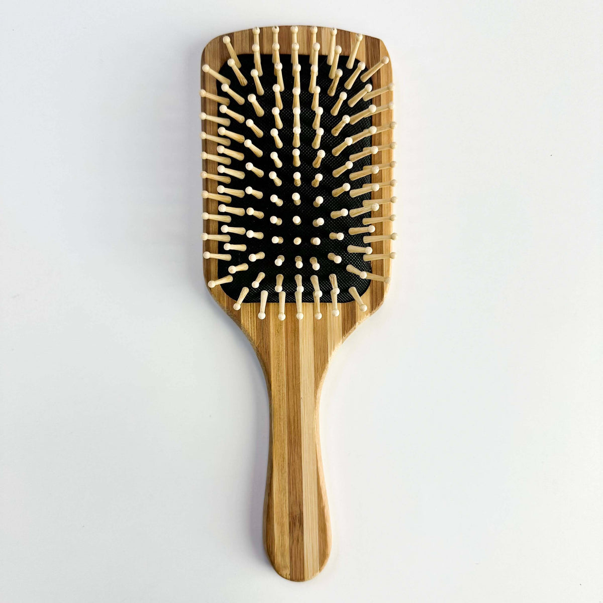 Bamboo Paddle Hair brush - Smile Boutiques with smooth bristles and bamboo handle for gentle hair care.