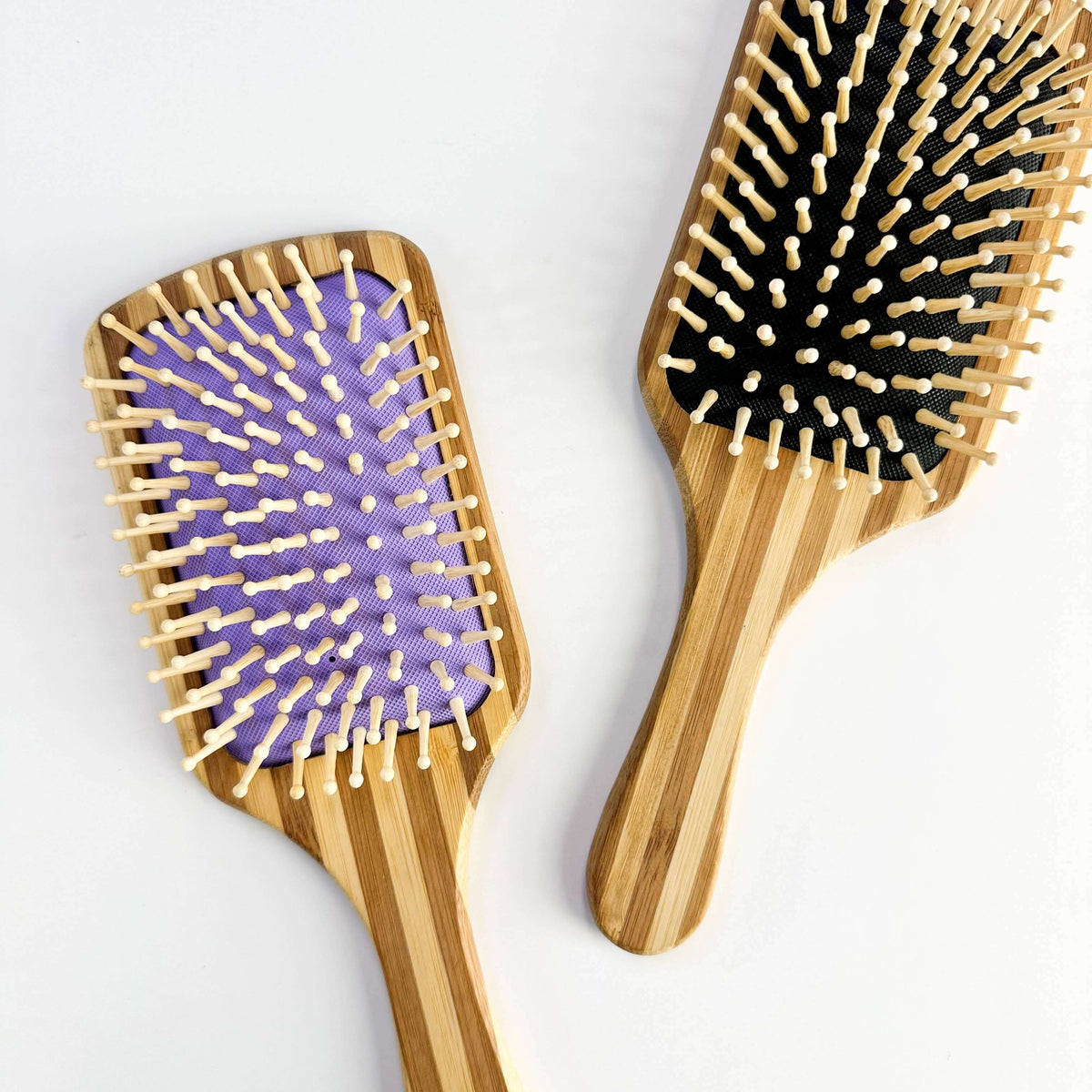 Bamboo Paddle Hair brush - Smile Boutiques in purple and black, showcasing smooth bristles for gentle hair care.