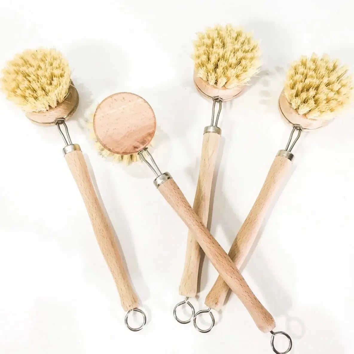 Set of five wooden cleaning brushes with natural bristles on a white background