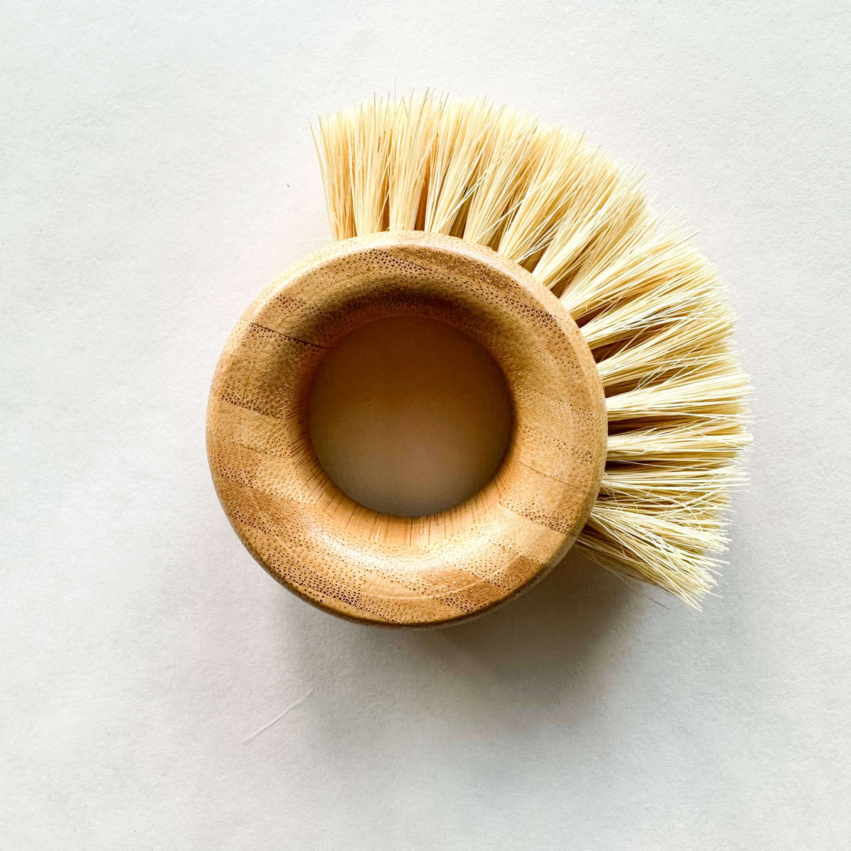 Bamboo Vegetable Brush - Smile Boutiques, a durable plastic-free kitchen and home scrubber for fruits and vegetables.
