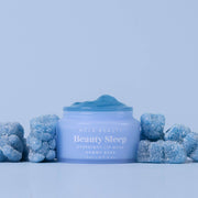 Blue lip mask jar with gummy bear-shaped candies on a light blue background