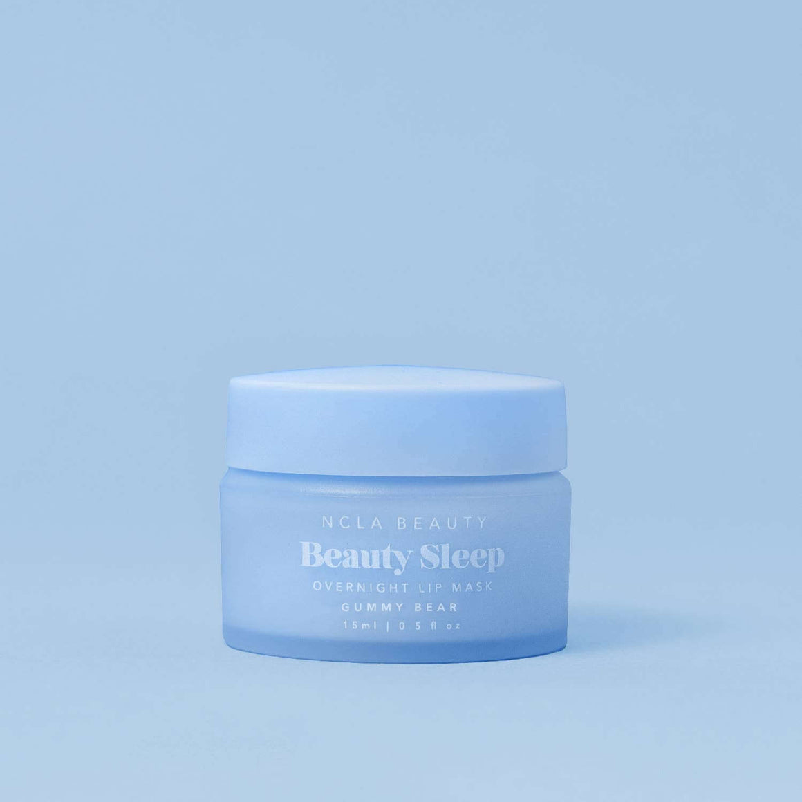 Blue jar of NCLA Beauty Beauty Sleep lip mask on a light blue background