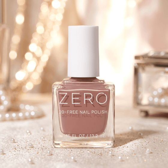 Bottle of ZERO nail polish with a soft pink color on a blurred background
