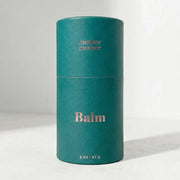 Teal cylindrical balm container with 'mother balm' branding on a white background