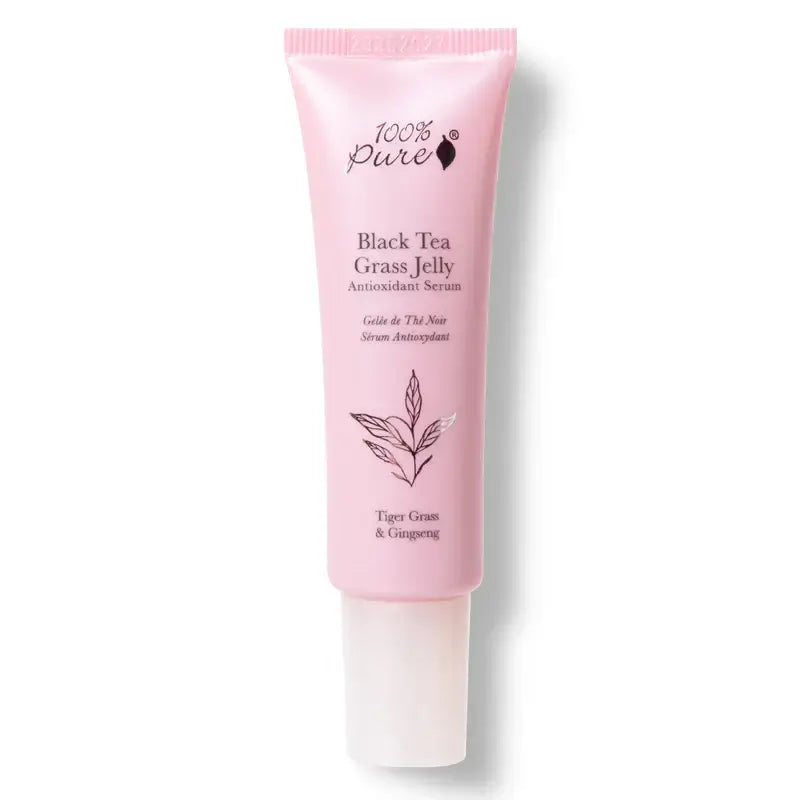 Pink skincare serum tube labeled '100% Pure Black Tea Grass Jelly' on a white background