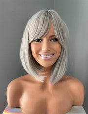 Yvette Short Silver Bob Wig featuring soft side-swept bangs and polished elegance on a mannequin.