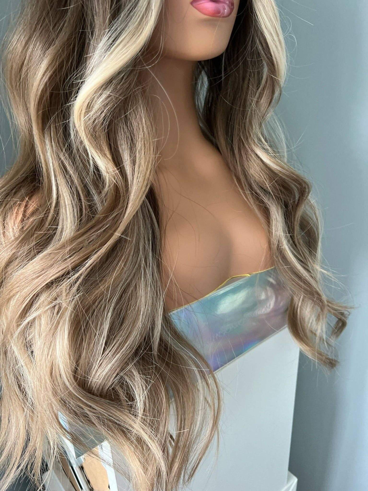 Brianna Long Brown Wig With Highlights featuring soft brown waves and blonde highlights, styled elegantly.