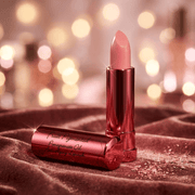 Calendula Fruit Pigmented® Pomegranate Oil Anti-Aging Lipstick in elegant packaging on soft fabric
