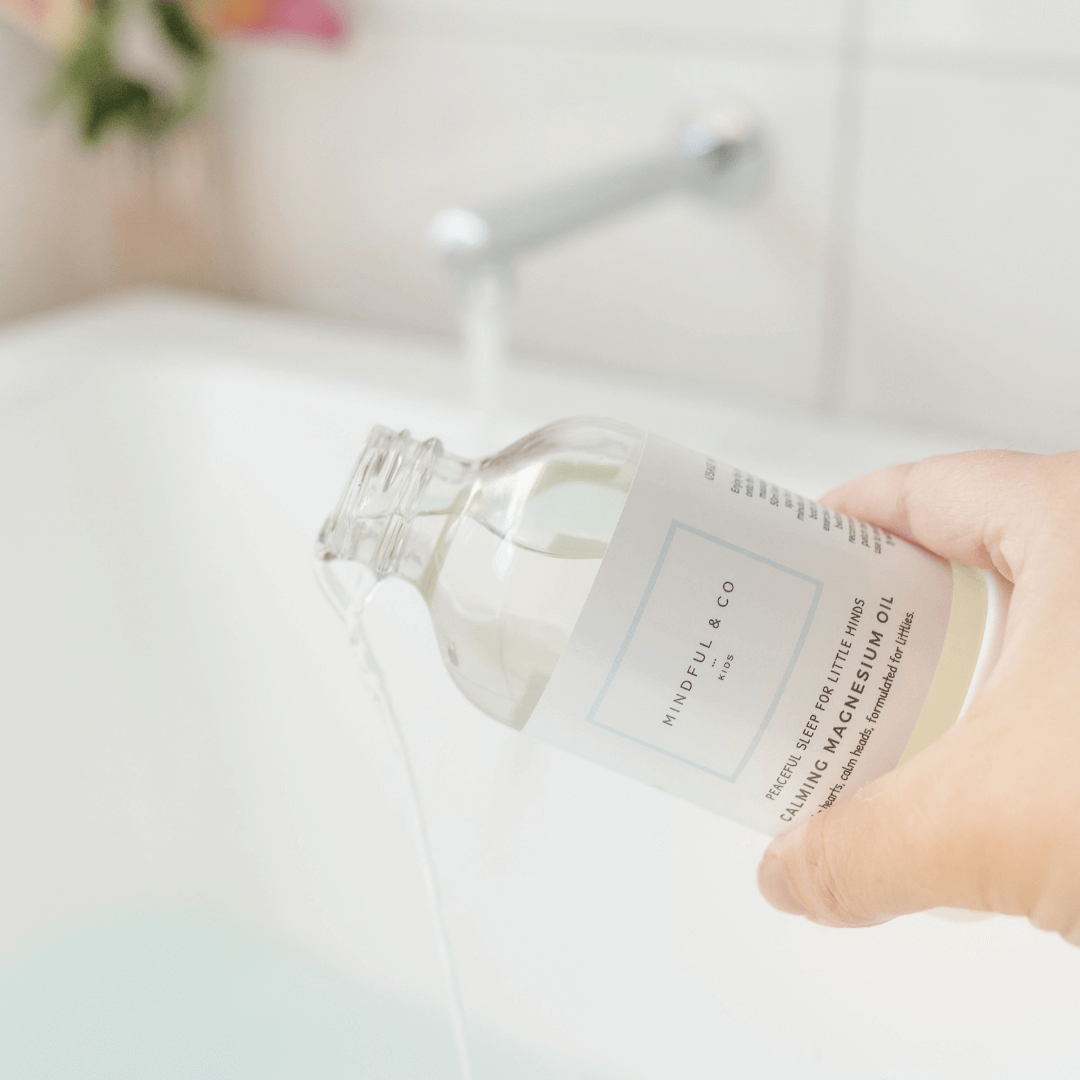 Hand holding a bottle of 'Mindful & Co' essential oil with a blurred background