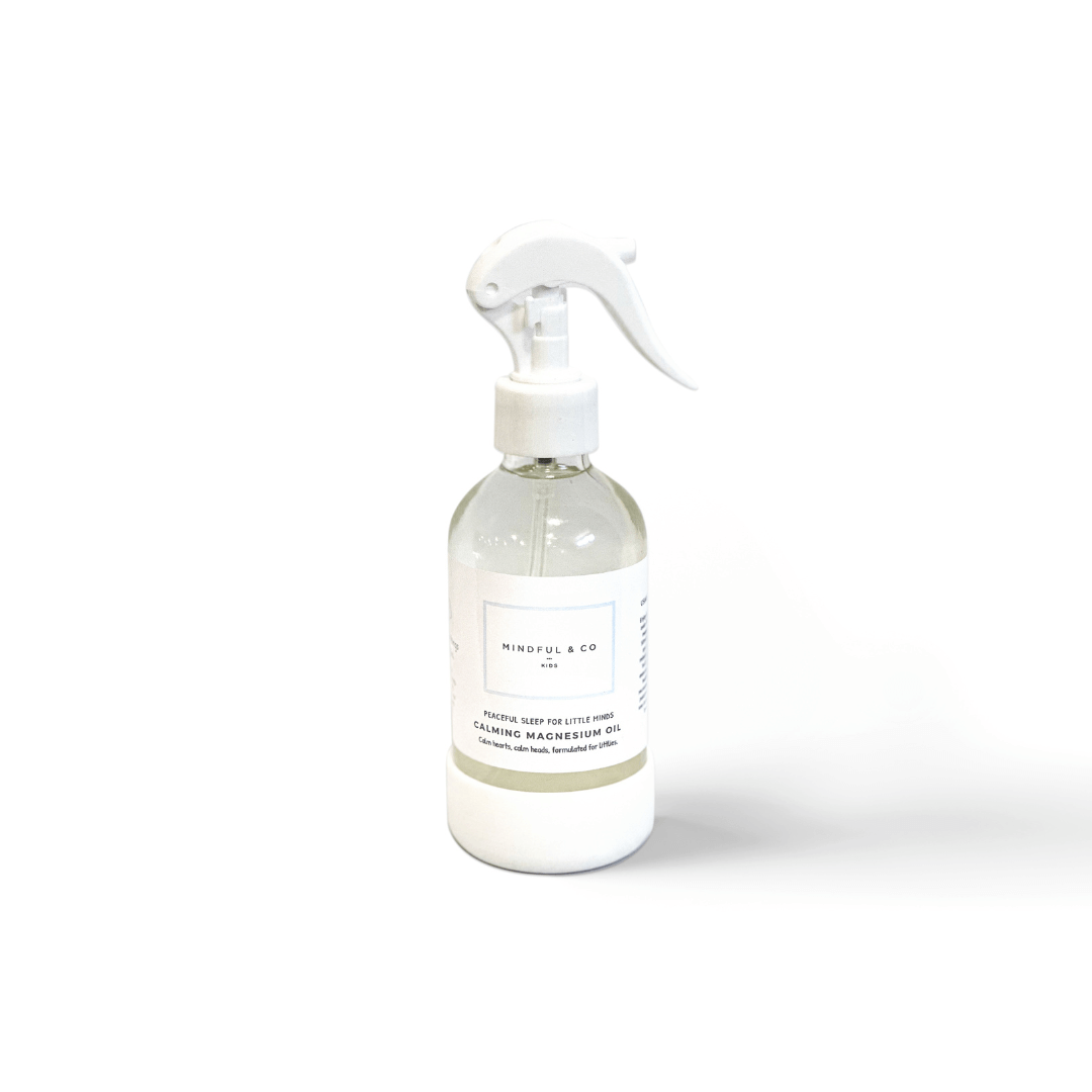Clear spray bottle with white nozzle on a white background
