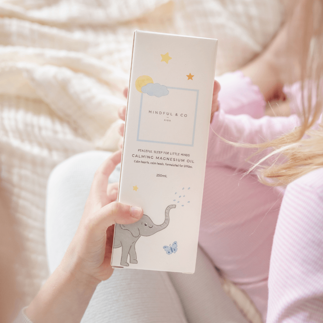 Person holding a box of Mindful & Co product with a soft pink background