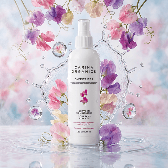 Carina Organics Sweet Pea leave-in conditioner bottle with flowers and water droplets in the background