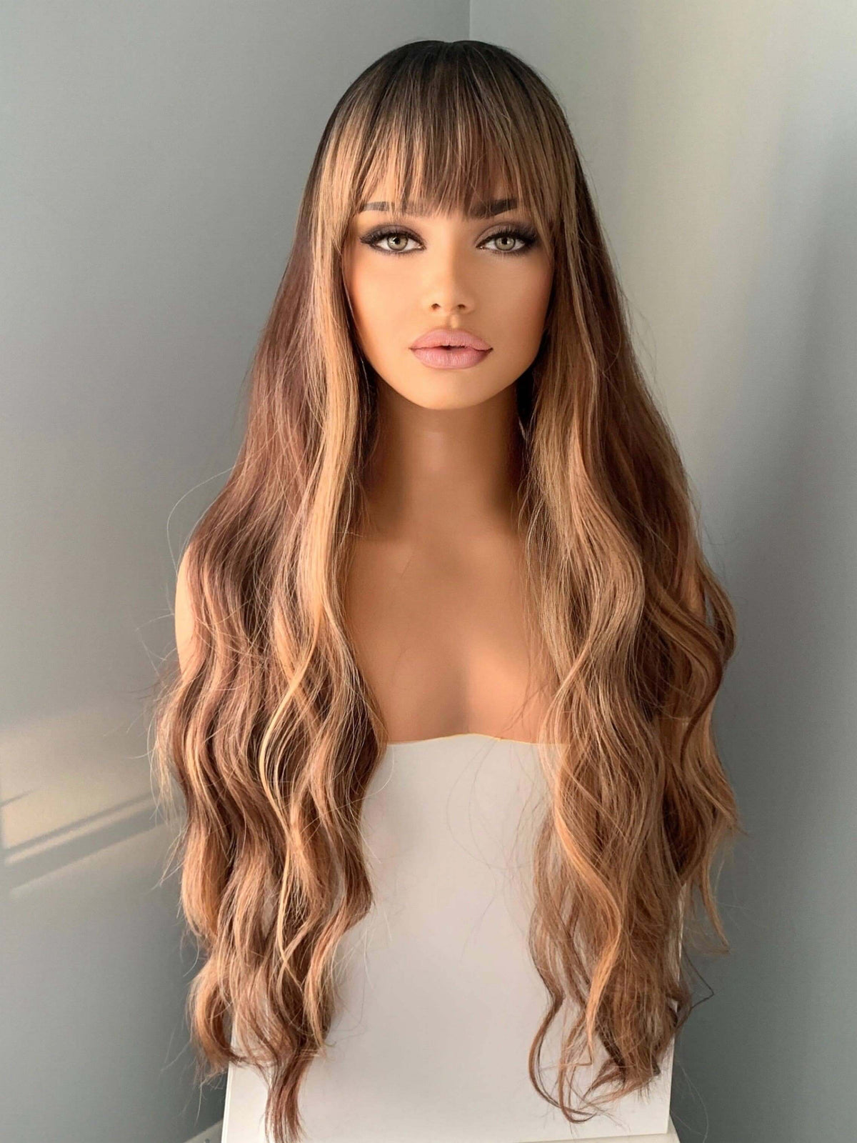 Carmen Long Highlighted Brown Body Wave Wig with Bangs, featuring soft waves and full bangs, perfect for glam looks. Highlighted Wig.