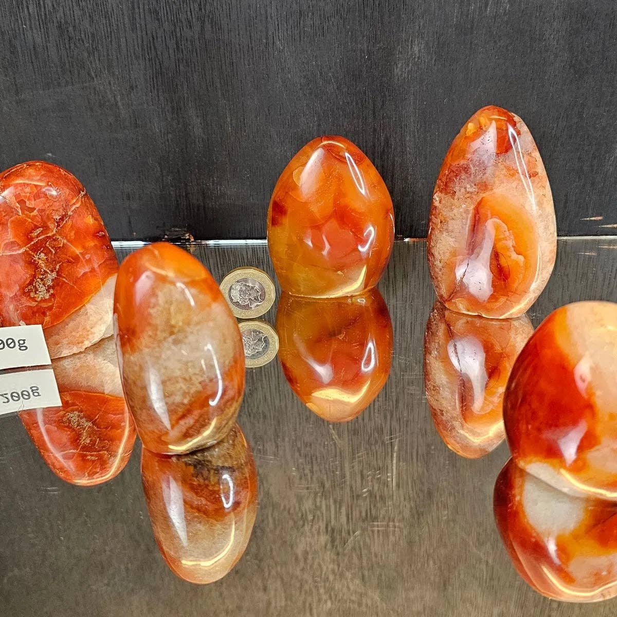 Red and white marbled stones on a reflective surface with a dark background