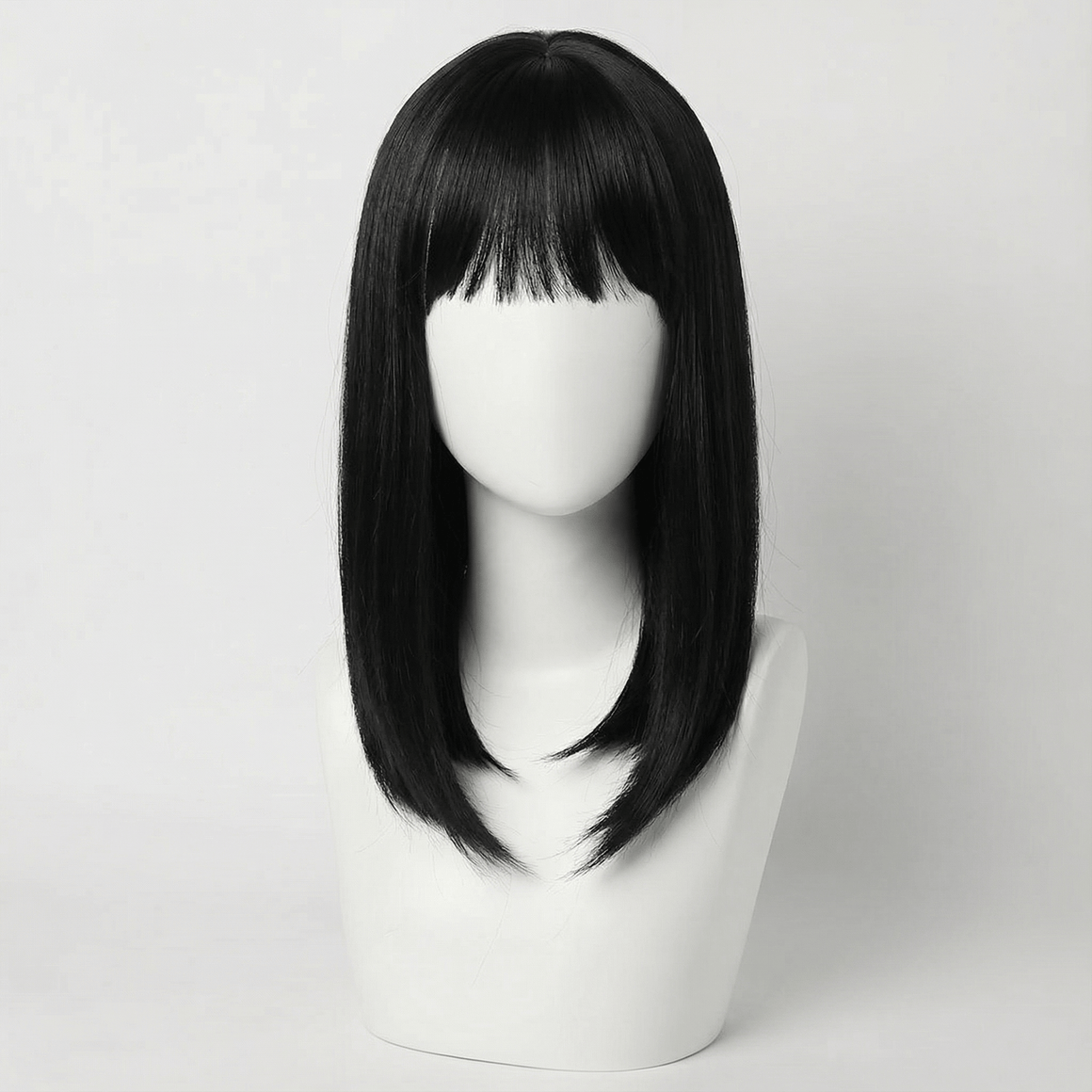 Cecil Short Black Wig with Bangs displayed on a wig stand, showcasing its sleek design and modern feathered bob.