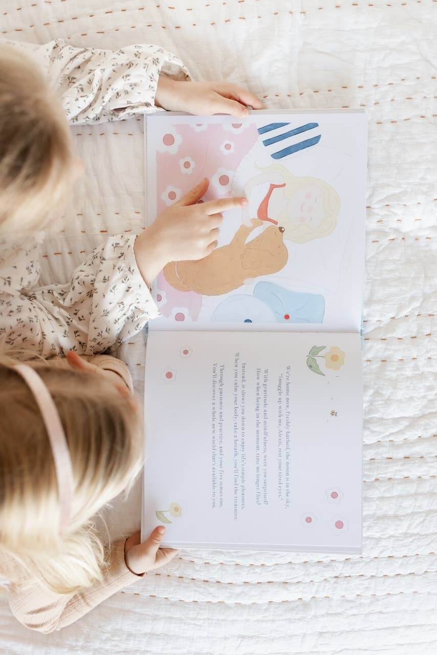 A child reading Charlie's Mindful Adventures By The Sea, engaging with colorful illustrations and mindful techniques.