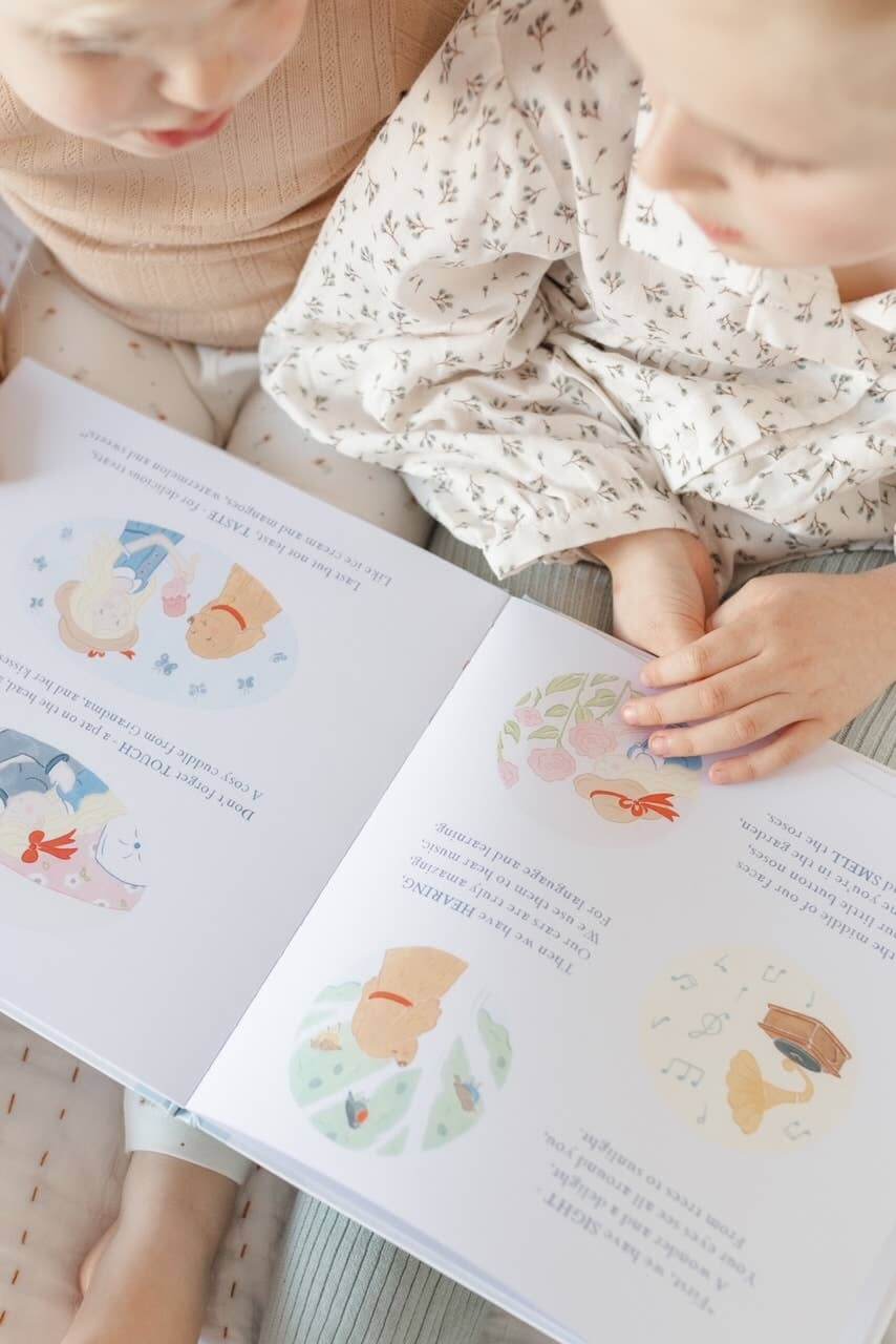 Two children reading Charlie's Mindful Adventures By The Sea, exploring mindfulness through colorful illustrations.