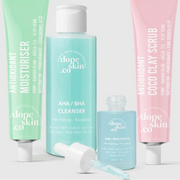 Four skincare products from dope skin co on a light gray background