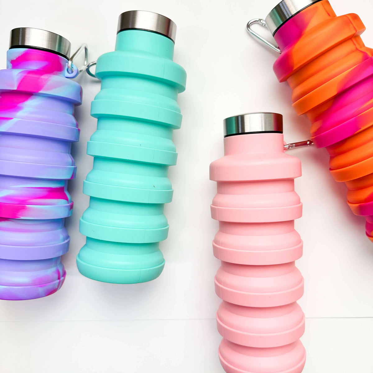 Collapsible water bottles in various colors on a white background