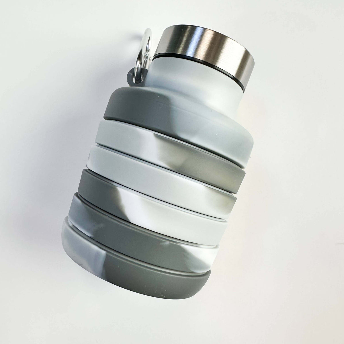 Collapsible water bottle with gray and silver design on a white background