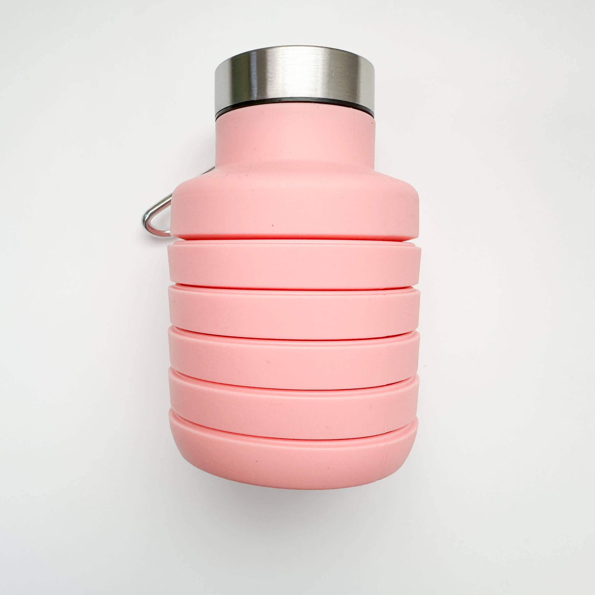 Pink collapsible water bottle with silver cap on a white background
