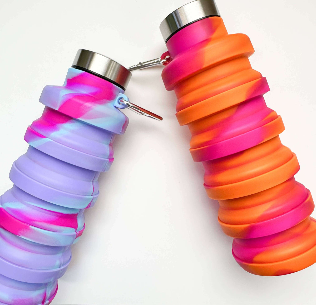 Two collapsible silicone water bottles with colorful designs on a white background