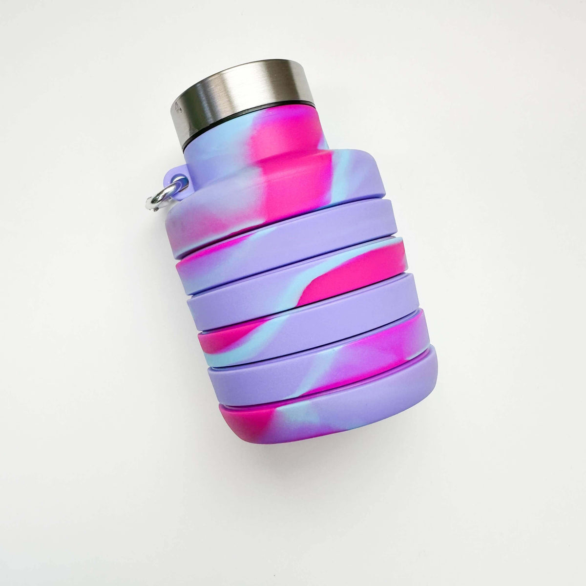 Collapsible water bottle with pink and purple gradient on a white background