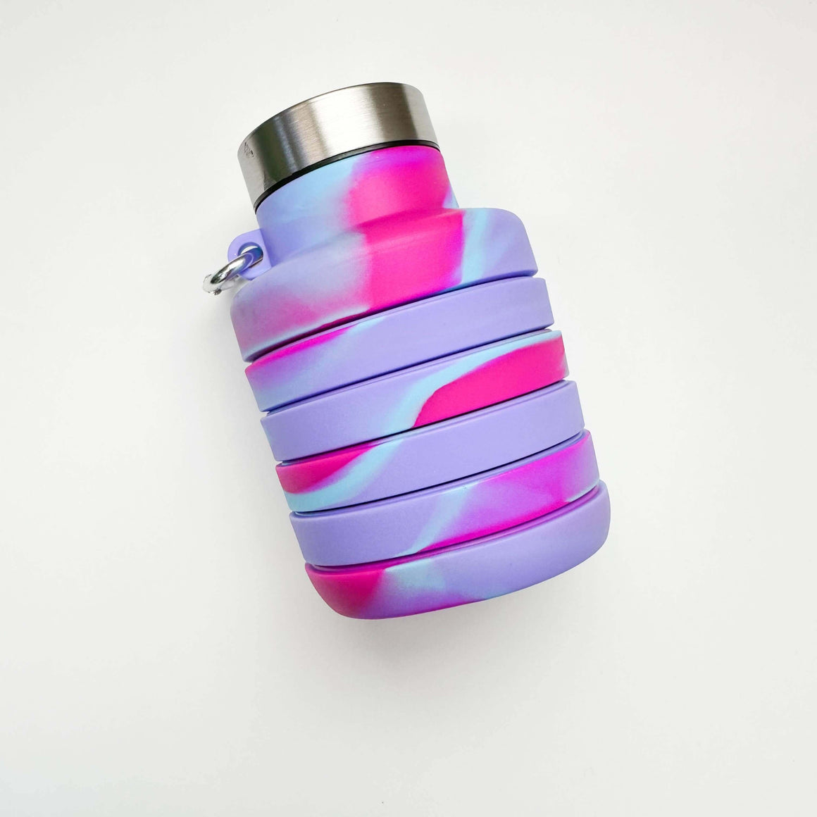 Collapsible water bottle with pink and purple gradient on a white background